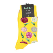 Close-up of yellow crew socks with a detailed chrysanthemum floral pattern.